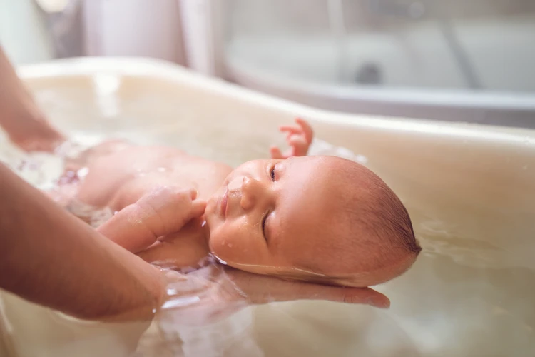 baby-being-bathed-by-parent